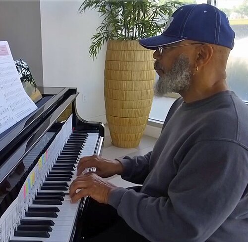 Senior playing piano as part of community programming connected to Joe Altepeter of EngAGE Inc. Senior playing piano as part of community programming connected to Joe Altepeter of EngAGE Inc.